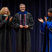 Provost and President applauding Brad Wallar